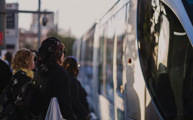 Waiting for the light rail in Jerusalem — strangers sharing space, journeys, and expectations of dignity (Levi Meir Clancy of Unsplash).