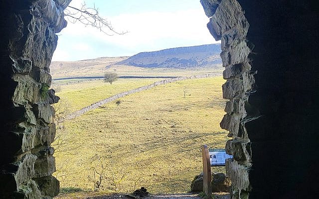 Doorway looking out onto rolling countryside - this particular instance, a doorway from a shepherd's hut looking out over the Yorkshire Dales at Ingleborough. (courtesy)