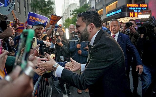 Democratic candidate Zohran Mamdani greets supporters upon arriving to participate in a mayoral debate, October 16, 2025, in New York. (AP Photo/Angelina Katsanis)