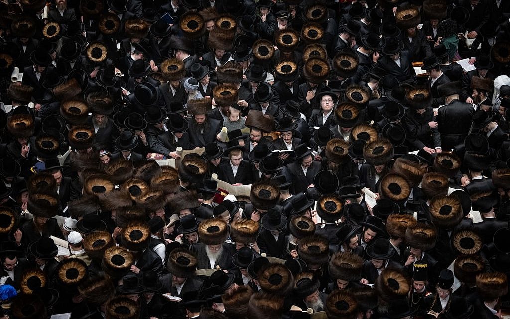 Ultra-Orthodox Jewish men and children read a Scroll of Esther, on the eve of Purim, inside the Belz Yeshiva in Jerusalem, March 24, 2024. (Yonatan Sindel/Flash90)