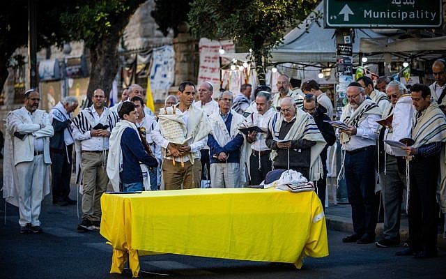 Jews pray in memory of the victims of the October 7th massacre and for the release of Israelis held hostage in the Gaza Strip, on the morning of the Jewish holiday of Simchat Torah, in Jerusalem, October 24, 2024. (Yonatan Sindel/Flash90)