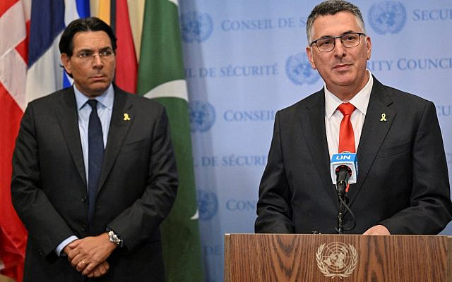 Foreign Minister Gideon Saar speaks to journalists as Israeli Ambassador to the UN Danny Danon looks on ahead of a UN Security Council meeting on the hostages and the Gaza war at the UN headquarters on August 5, 2025, in New York (Photo by Angela Weiss/AFP)