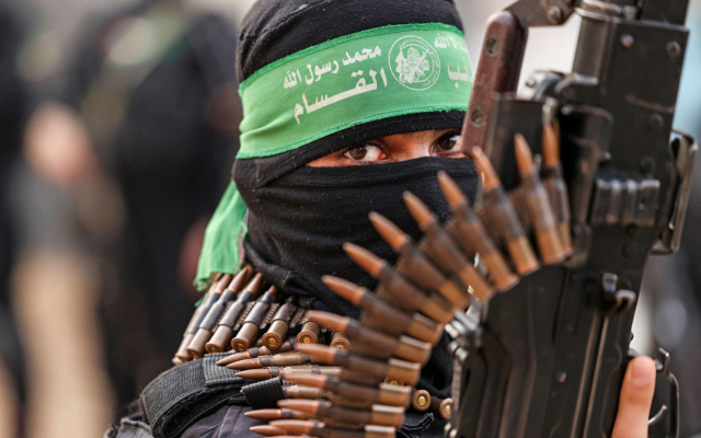 A member of Ezzedine al-Qassam Brigades, military wing of the Palestinian Hamas movement, takes part in a parade in Gaza City on November 14, 2021. (MAHMUD HAMS / AFP) A member of Ezzedine al-Qassam Brigades, military wing of the Palestinian Hamas movement, takes part in a parade in Gaza City on November 14, 2021. (MAHMUD HAMS / AFP)