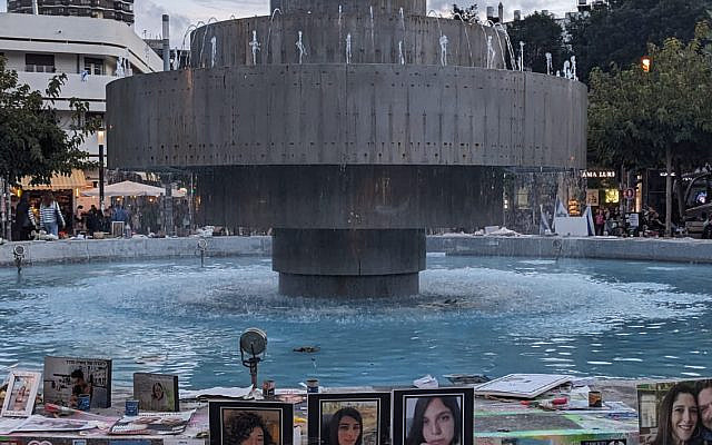 The fountain in Dizengoff Square is adorned with posters and stickers commemorating fallen IDF soldiers.