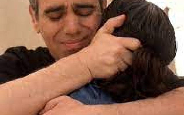 Released hostage Omri Miran reunites with his wife Lishay Miran-Lavi after over two years in Hamas captivity, at the Re'im base on October 13, 2025. (Israel Defense Forces)