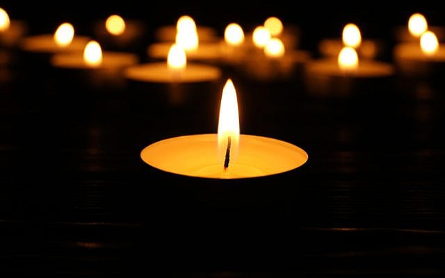 Burning candle in darkness, closeup. Memory day