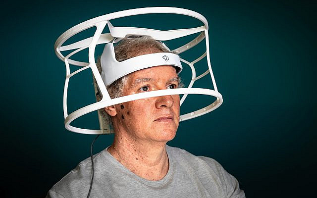 Yaron Segal wearing the brainwave helmet he invented to help stroke patients recover. Picture: John Jeffay