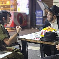 A soldier and yeshiva student having a heated discussion regarding the draft.Source: Avromi Mostofsky A soldier and yeshiva student having a heated discussion regarding the draft.Source: Avromi Mostofsky