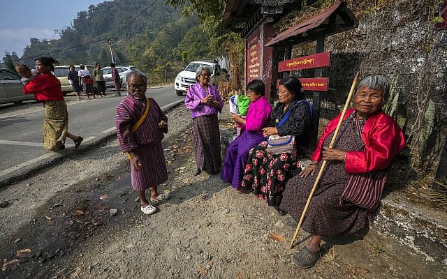 Villagers in traditional attire take rest after casting their votes, outside a polling centre during general election in Rikhey village, Bhutan, Tuesday, Jan. 9, 2024. (AP Photo/Anupam Nath)