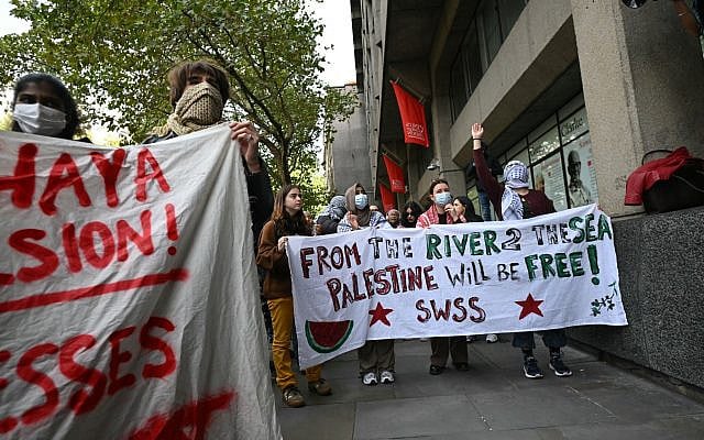 Pro-Palestinian and anti-Israel student protesters hold a banner with the slogan 'From the river 2 the sea Palestine will be free' written on it outside King's College London during an inter-university march for Gaza in London on October 7, 2025, the second anniversary of the deadly Hamas-led attack on Israel which sparked a retaliatory offensive in Gaza. (JUSTIN TALLIS / AFP)