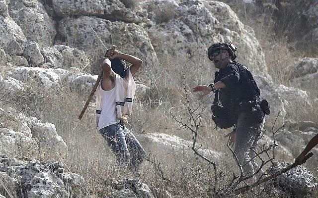 Jewish settler attacks a journalist during the olive-picking season in the village of Beita, south of Nablus in the West Bank, November 8, 2025. (Nasser Ishtayeh/Flash90) Jewish settler attacks a journalist during the olive-picking season in the village of Beita, south of Nablus in the West Bank, November 8, 2025. (Nasser Ishtayeh/Flash90)