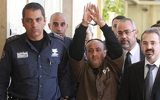 Fatah terror chief Marwan Barghouti, serving five life terms for murder during the Second Intifada, is escorted by Israeli police into Jerusalem's Magistrate Court to testify as part of a US civil lawsuit against Palestinian leaders, in January 2012. (Flash90)