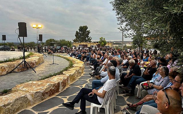 Illustrative. A ceremony at Netiv Ha'asara on October 6, 2024, commemorating the 20 residents who were slain by Hamas on October 7, 2023. (Shalom Yerushalmi / Times of Israel)
