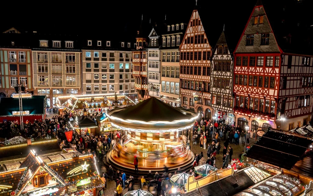 Lights illuminate the traditional Christmas market with a merry-go-round, in Frankfurt, Germany, November 21, 2022. (AP/Michael Probst, File)