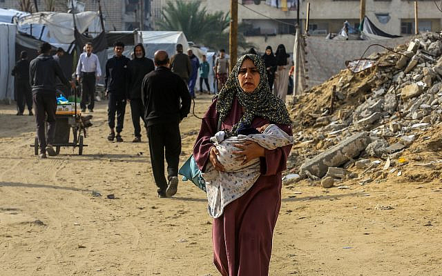 Palestinians live among buildings destroyed during the recent war in Khan Yunis, in the southern Gaza Strip, November 29, 2025. (Abed Rahim Khatib/Flash90)