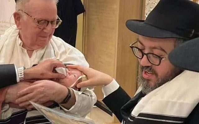 Rabbi Eliyahu Schlinger, a Chabad emissary in Sydney since 2008, pictured with his infant son. Schlinger was murdered while organizing a public Hanukkah celebration