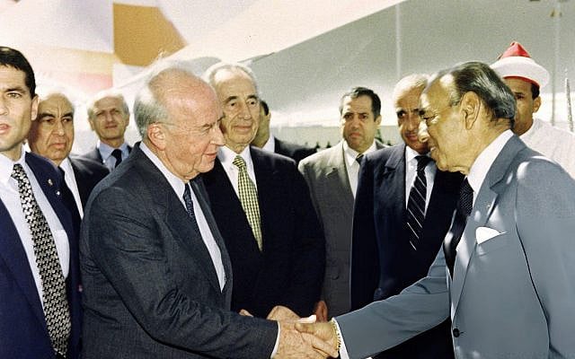 Israeli Prime Minister Yitzhak Rabin (L), flanked by Foreign Minister Shimon Peres, shakes hands with King Hassan II of Morocco on September 14, 1993 in Rabat. Credit: Staff / AFP