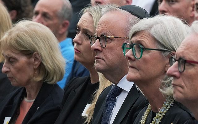 Australia's Prime Minister Anthony Albanese (center right) his wife Jodie Haydon (center left) and other guests participate in a ceremony to mark the National Day of Reflection for victims and survivors, at Bondi Beach in Sydney, December 21, 2025, following the terror attack targeting a Hanukkah celebration a week earlier. (AP/Mark Baker) Australia's Prime Minister Anthony Albanese (center right) his wife Jodie Haydon (center left) and other guests participate in a ceremony to mark the National Day of Reflection for victims and survivors, at Bondi Beach in Sydney, December 21, 2025, following the terror attack targeting a Hanukkah celebration a week earlier. (AP/Mark Baker)