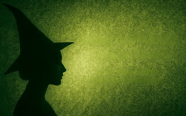 Silhouette of a witch against a green backdrop (AI-generated, courtesy)
