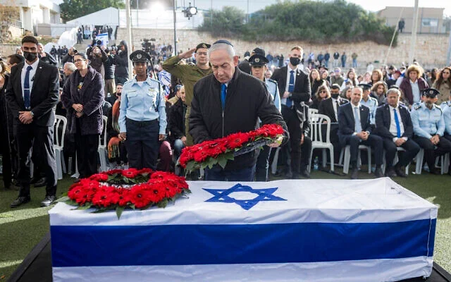 Prime Minister Benjamin Netanyahu lays a wreath of flowers on the casket of hostage Ran Gvili, whose remains were finally brought back to Israel on January 26, during the funeral in the southern town of Meitar on January 28, 2026. (Photo by Chaim Goldberg / POOL / AFP)