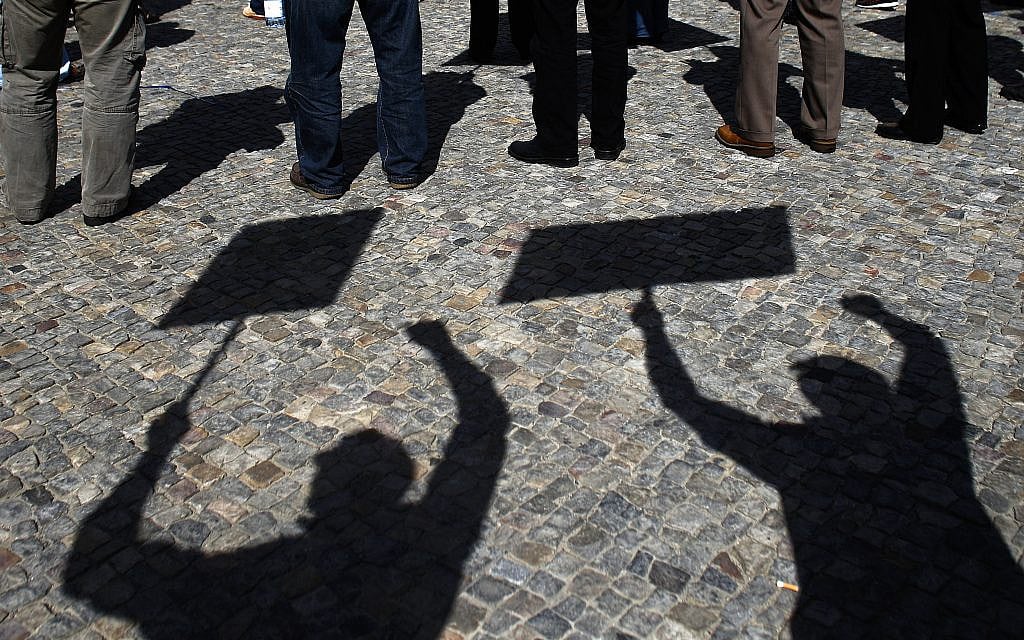 Illustrative: Protesters cast their shadows on the ground during a demonstration for free elections in Iran, in Berlin, June 11, 2013. (AP/Markus Schreiber) Illustrative: Protesters cast their shadows on the ground during a demonstration for free elections in Iran, in Berlin, June 11, 2013. (AP/Markus Schreiber)