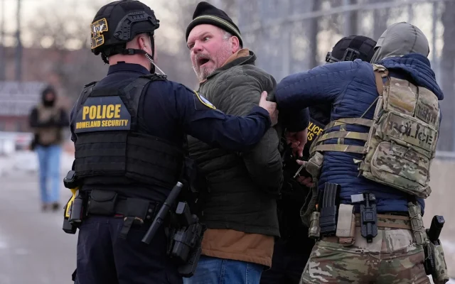 Law enforcement detain a man outside the Bishop Henry Whipple Federal Building during a protest on Saturday, Jan. 17, 2026, in Minneapolis. (AP Photo/Yuki Iwamura)