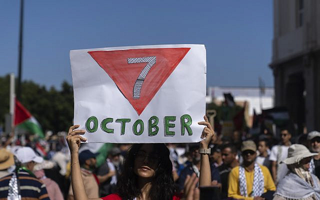 A woman carries a sign commemorating the Oct. 7 attacks, during a rally in support of people in Gaza and Lebanon, in Rabat, Morocco, Sunday, Oct. 6, 2024. (AP Photo/Mosa'ab Elshamy)