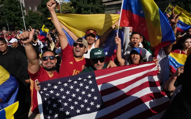Venezuelans celebrate after US President Donald Trump announced that Venezuelan President Nicolas Maduro had been captured and flown out of the country in Santiago, Chile, Saturday, Jan. 3, 2026. (AP Photo/Esteban Felix)