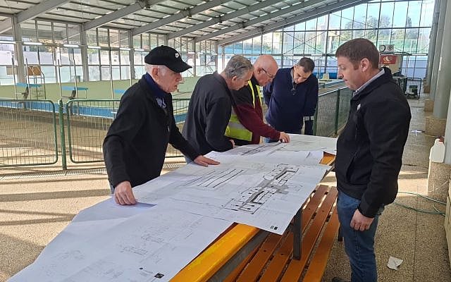 Renovation team discussing the overhaul of the Israel ParaSport Center’s semi-Olympic pool (photo from Israel ParaSport Center's collection)