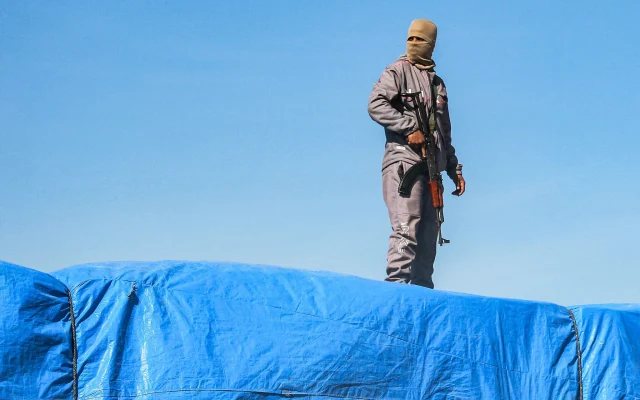 A member of security forces loyal to Hamas stands guard atop a truck carrying humanitarian aid coming in from the Kerem Shalom Crossing, near Gaza's southernmost city of Rafah, on January 21, 2025. (Bashar Taleb/AFP) A member of security forces loyal to Hamas stands guard atop a truck carrying humanitarian aid coming in from the Kerem Shalom Crossing, near Gaza's southernmost city of Rafah, on January 21, 2025. (Bashar Taleb/AFP)