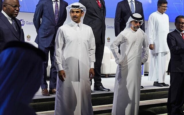 Qatar's Minister of State for Energy Affairs Saad Sherida al-Kaabi, center left, awaits a posed portrait with Emirati Energy and Infrastructure Minister Suhail al-Mazrouei, center right, during Gastech 2021 conference in Dubai, United Arab Emirates, Tuesday, Sept. 21, 2021. Energy officials from Qatar and Turkey, long-standing foes of the United Arab Emirates, descended on Dubai along with hundreds of other executives on Tuesday, flocking to the largest gas expo in the world and the industry's first in-person conference since the pandemic began. (AP Photo/Jon Gambrell) Qatar's Minister of State for Energy Affairs Saad Sherida al-Kaabi, center left, awaits a posed portrait with Emirati Energy and Infrastructure Minister Suhail al-Mazrouei, center right, during Gastech 2021 conference in Dubai, United Arab Emirates, Tuesday, Sept. 21, 2021. Energy officials from Qatar and Turkey, long-standing foes of the United Arab Emirates, descended on Dubai along with hundreds of other executives on Tuesday, flocking to the largest gas expo in the world and the industry's first in-person conference since the pandemic began. (AP Photo/Jon Gambrell)