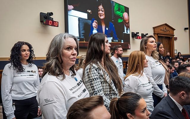At the request of Rep. Pramila Jayapal, seen on TV monitor, survivors of convicted sex trafficker Jeffrey Epstein stand in the audience as Attorney General Pam Bondi testifies before the House Judiciary Committee over the Justice Department's handling of files related to Epstein that have exposed sensitive private information about victims despite redaction efforts, February 11, 2026. (AP Photo/J. Scott Applewhite)