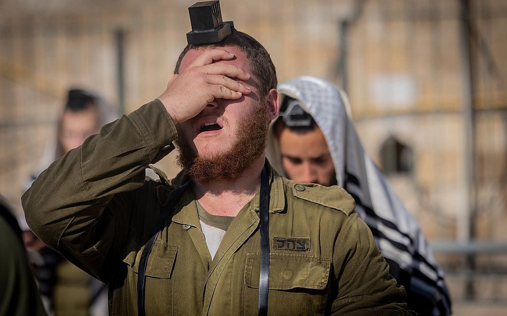 Ultra-Orthodox Jewish soldiers from the Hasmonean Brigade take part in a beret march after completing seven months of basic and advanced training, at the Western Wall in Jerusalem's Old city on August 6, 2025. (Chaim Goldberg/Flash90)
