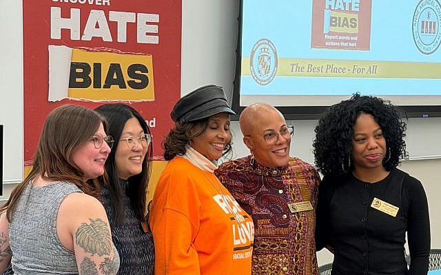 Organizers of conference to end hate bias stand with Dawn Collins whose son was murdered in a hate crime.  Photo by and courtesy of JLM.