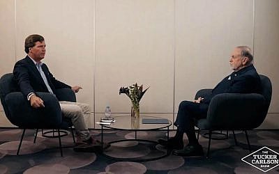 Tucker Carlson interviews U.S. Ambassador to Israel Mike Huckabee at Ben Gurion Airport in a podcast episode published on February 20, 2026. (Screenshot/X)