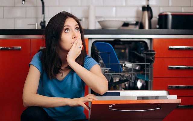Illustrative. A woman with a broken dishwasher. (iStock)