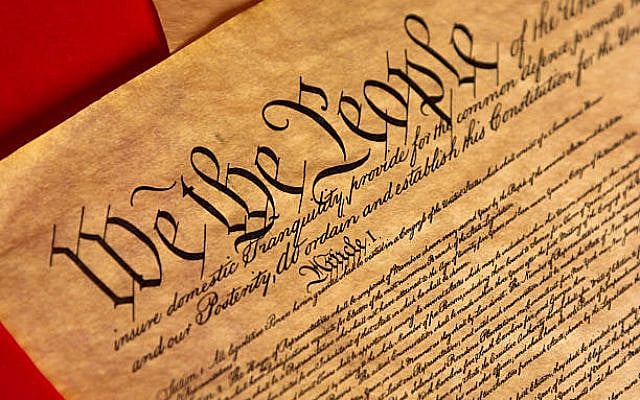 A parchment of the Constitution of the United States with a red background