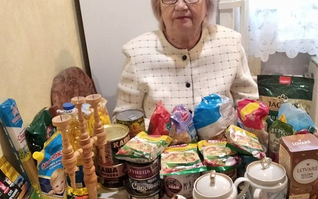 Elderly woman, surrounded by non perisable food items, for use during prolonged blackouts. As part of a winter survival kit by Action -PSJ. Pic courtsey of APSJ