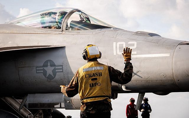 A US sailor signals to an F/A-18E Super Hornet aircraft, attached to Strike Fighter Squadron 37, on the flight deck of the world’s largest aircraft carrier, USS Gerald R. Ford, while operating in support of Operation Epic Fury in the Eastern Mediterranean Sea, March 2, 2026. (US Navy photo)