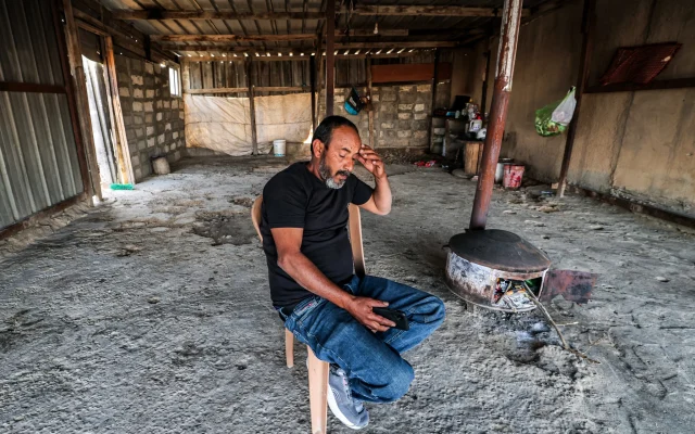 Mohamad Hassouna, who resides in the unrecognized Bedouin village of Al-Fura, sits in a building near where his 7-year-old daughter Amina was injured by an Iranian missile shard in the southern Negev desert on April 14, 2024. (Ahmad Gharabli/AFP)