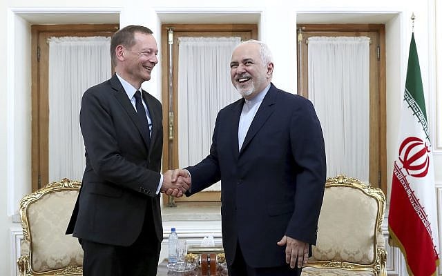 Iranian Foreign Minister Mohammad Javad Zarif, right, shakes hand with French presidential envoy Emmanuel Bonne, as they pose for photos, in Tehran, Iran, Wednesday, July 10, 2019. (AP Photo/Ebrahim Noroozi)