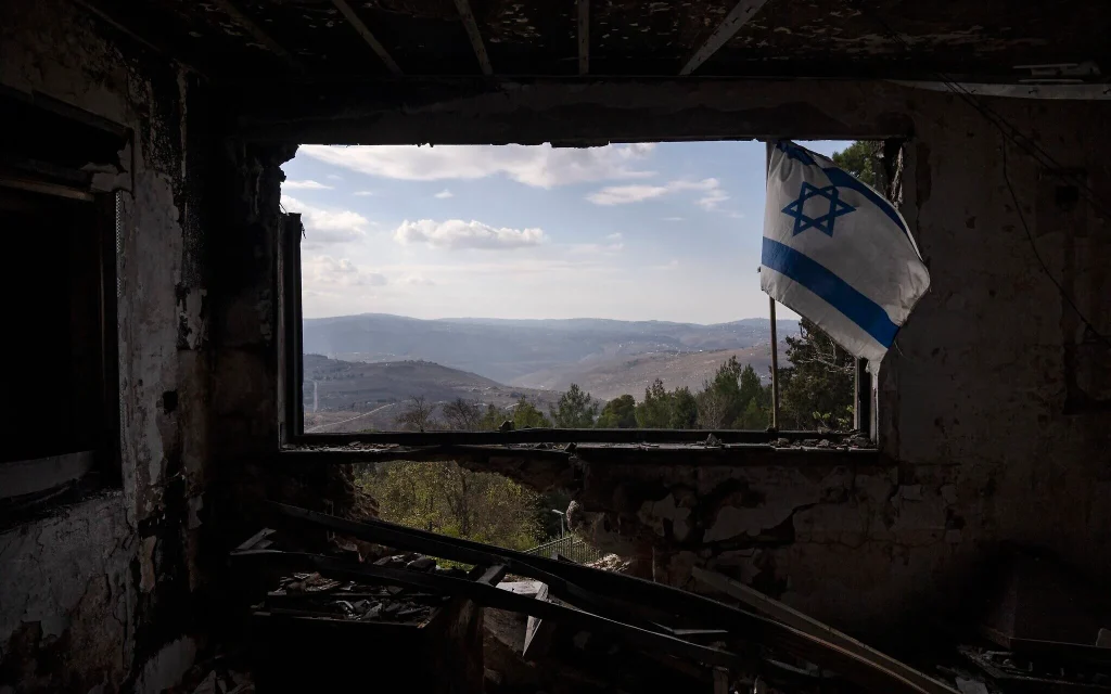 A Lebanese village is seen through a window of a damaged house that was hit by a rocket fired from Lebanon, in Kibbutz Manara in northern Israel, November 28, 2024. (AP Photo/Leo Correa)