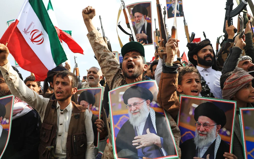 Houthi supporters hold posters of the late Iranian supreme leader ayatollah Ali Khamenei and Iranian flags during a rally against Israel and the United States in Sanaa, Yemen, Sunday, March 1, 2026. (AP Photo/Osamah Abdulrahman)