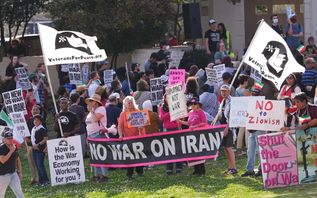 Protestors demonstrate against the US and Israeli strikes on Iran at Dealey Plaza in downtown Dallas, March 1, 2026. (AP Photo/LM Otero)