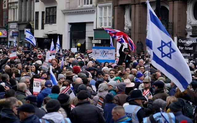 Protesters hold placards, flags and banners during a rally against antisemitism in London, Nov. 26, 2023. (AP Photo/Alberto Pezzali)