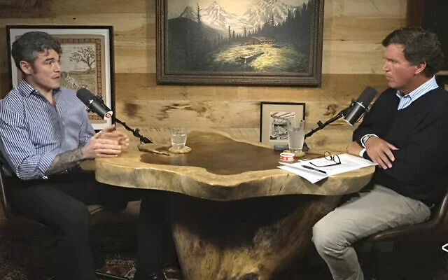 Just a couple of dudes asking questions: Tucker Carlson interviews conspiracy theorist Joe Kent.  (Screenshot via YouTube)