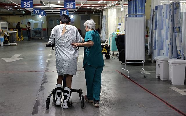 A physiotherapist assists a patient walking in the hospital department built at the underground parking of Hadassah Ein Kerem Hospital in Jerusalem.
Photo: Ariel Jerozolimski