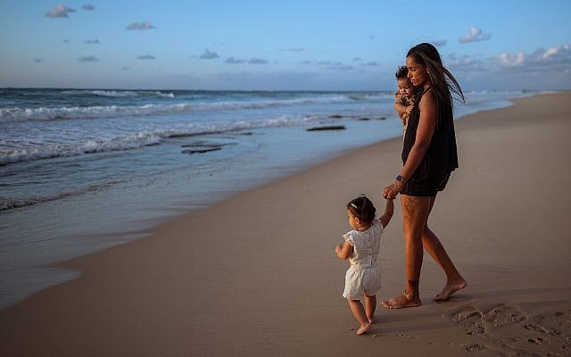 Shosh Hobelashvili with her two children on Ashkelon Beach. Her husband, Avi Hobelashvili, was killed while battling terrorists at the Nova music festival on October 7, 2023. (Credit: Maayan Firuz)