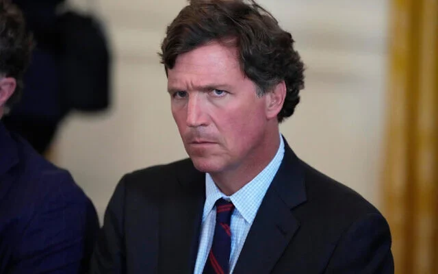 Tucker Carlson attends a meeting with US President Donald Trump and oil executives in the East Room of the White House, in Washington, DC, January 9, 2026. (AP/Alex Brandon)