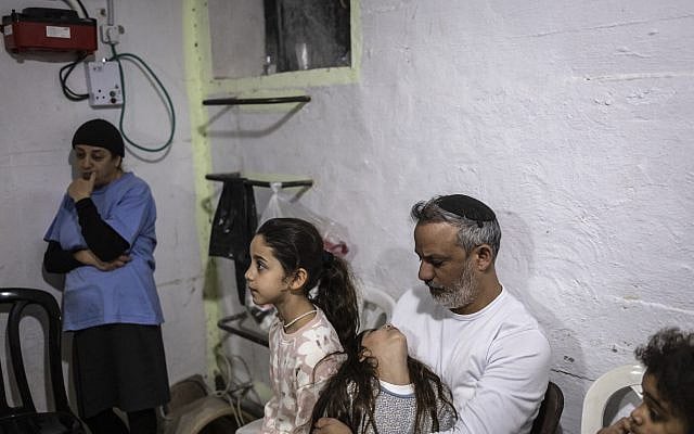 Illustrative. People wait in a bomb shelter during a siren alert for a reported incoming Iranian missile strike near the coastal city of Tel Aviv, on March 5, 2026. (Olympia de Maismont/AFP)